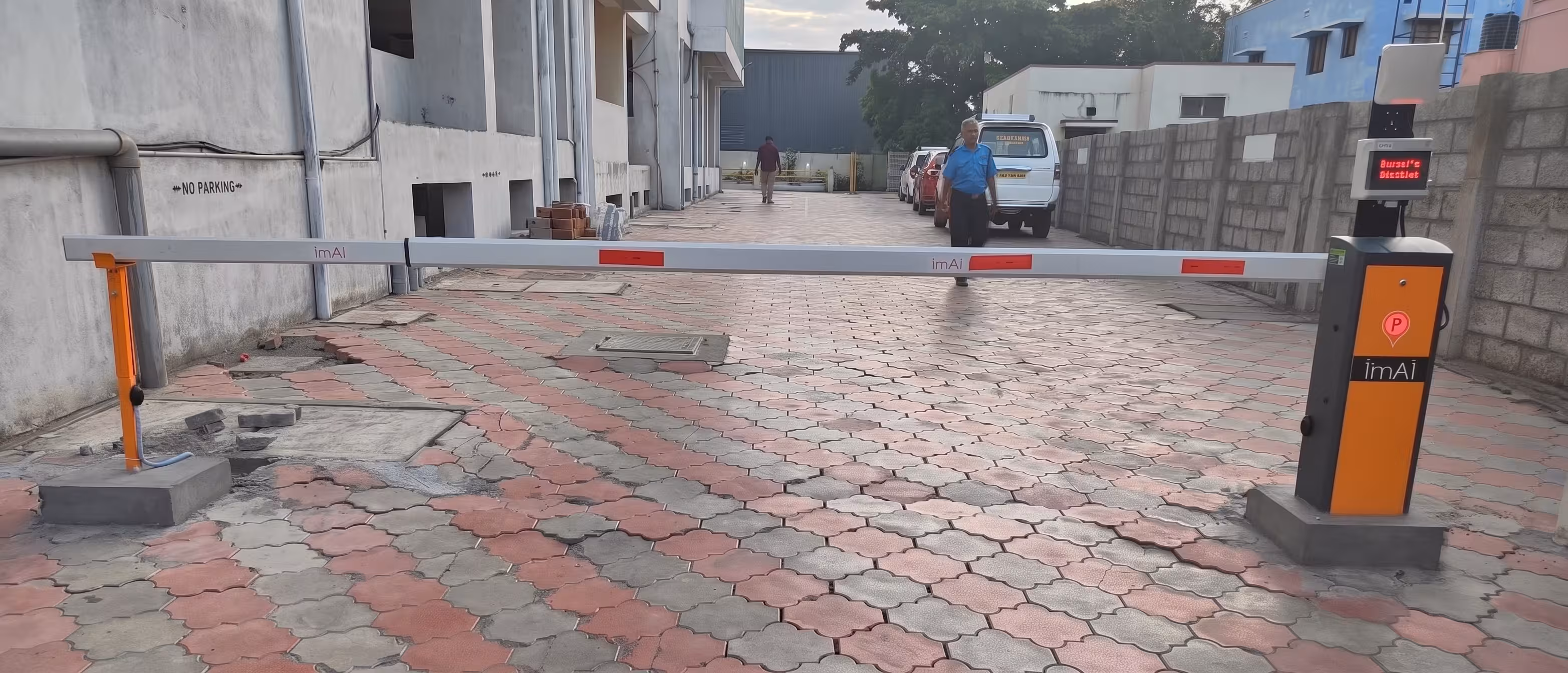 imAI dual-gate smart boom barrier system with RFID display entry and AI vehicle detection exit at Ramani West Gate Apartments Coimbatore